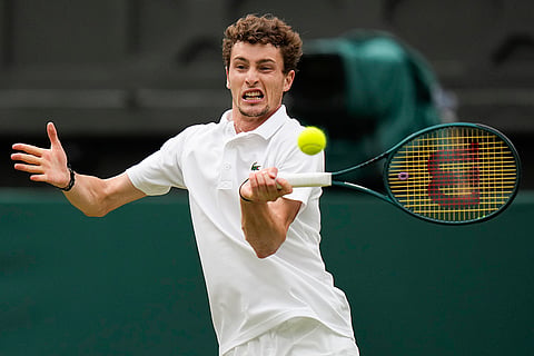 Ugo Humbert plays a forehand return to Carlos Alcaraz